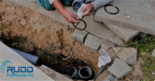 Rudd plumber working on a sewer pipe